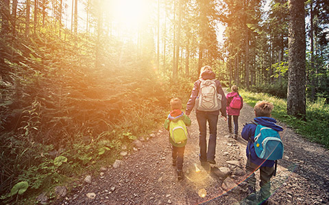 Mother & children walking nature trail 